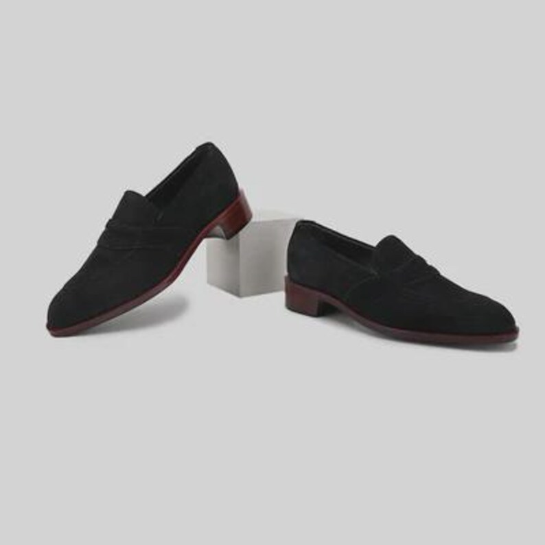 Handmade black suede penny loafers for men featuring a classic slip on silhouette, premium suede leather upper, leather sole, elegant formal design, luxury dress footwear ideal for weddings, business attire, office wear, and special occasions.