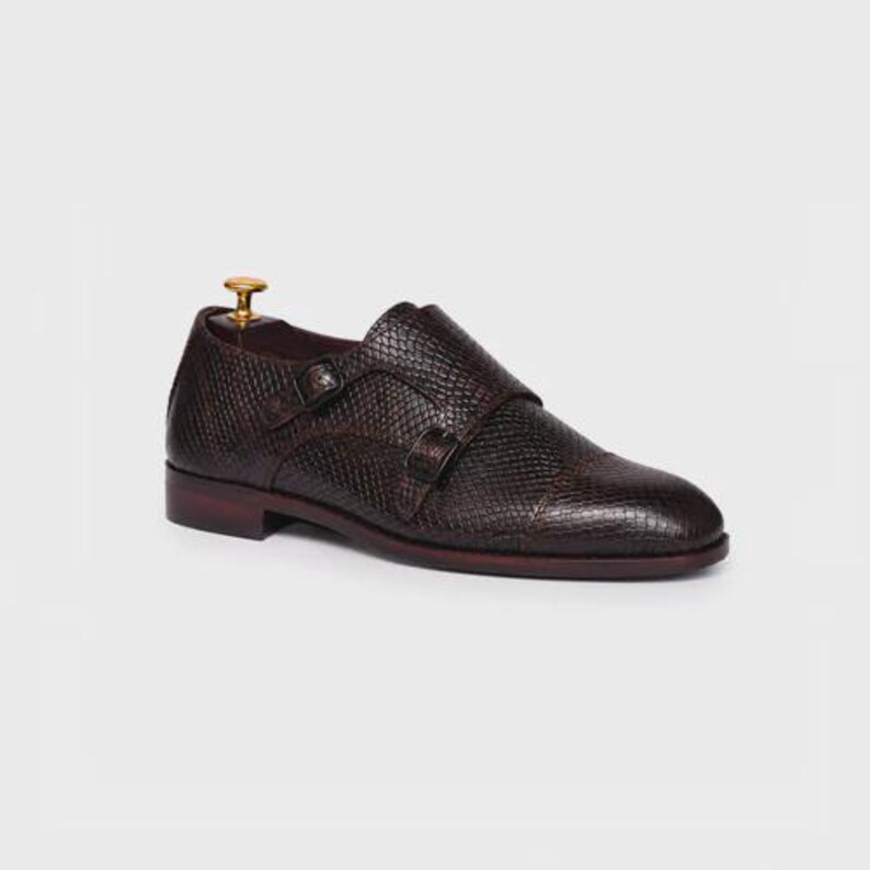 Handmade brown double monk strap shoes for men featuring snake embossed leather texture, cap toe design, dual buckle closure, leather lining and sole, luxury formal footwear ideal for weddings, business attire, office wear, and special occasions.