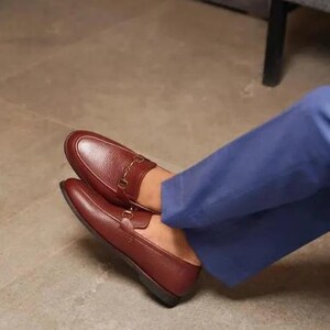 Handmade brown pebbled leather horsebit loafers for men featuring silver hardware, genuine leather lining, slip-on construction, and a luxury formal dress shoe design.