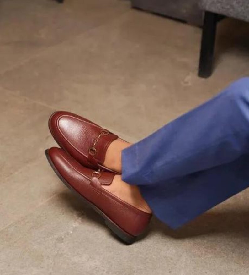 Handmade brown pebbled leather horsebit loafers for men featuring silver hardware, genuine leather lining, slip-on construction, and a luxury formal dress shoe design.