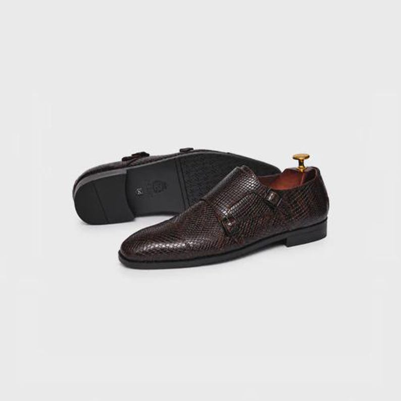 Handmade brown double monk strap shoes for men featuring snake embossed leather texture, cap toe design, dual buckle closure, leather lining and sole, luxury formal footwear ideal for weddings, business attire, office wear, and special occasions.