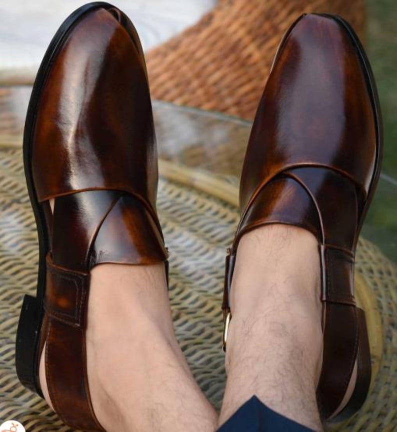 May include: Dark brown leather sandals with a polished finish. The sandals feature a closed-toe design, a strap across the top, and a buckle fastening. The shoes are a deep brown colour.