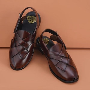 Handmade brown leather Peshawari sandals with woven closed-toe design and adjustable buckle for men's traditional and formal wear.