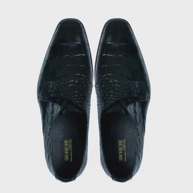 Handmade black crocodile embossed leather monk strap loafers for men featuring a textured buckle strap, premium leather lining, elegant slip-on design, and luxury craftsmanship for weddings, office wear, business meetings, and formal occasions.