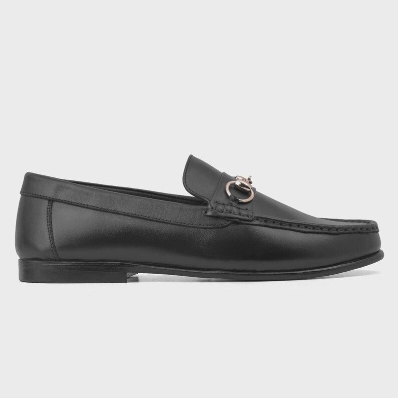 Handmade black leather horsebit loafers for men featuring polished premium leather and silver-tone hardware, luxury slip-on dress shoes ideal for weddings, groom attire, office wear, business meetings, formal events, parties, and sophisticated gentleman style.