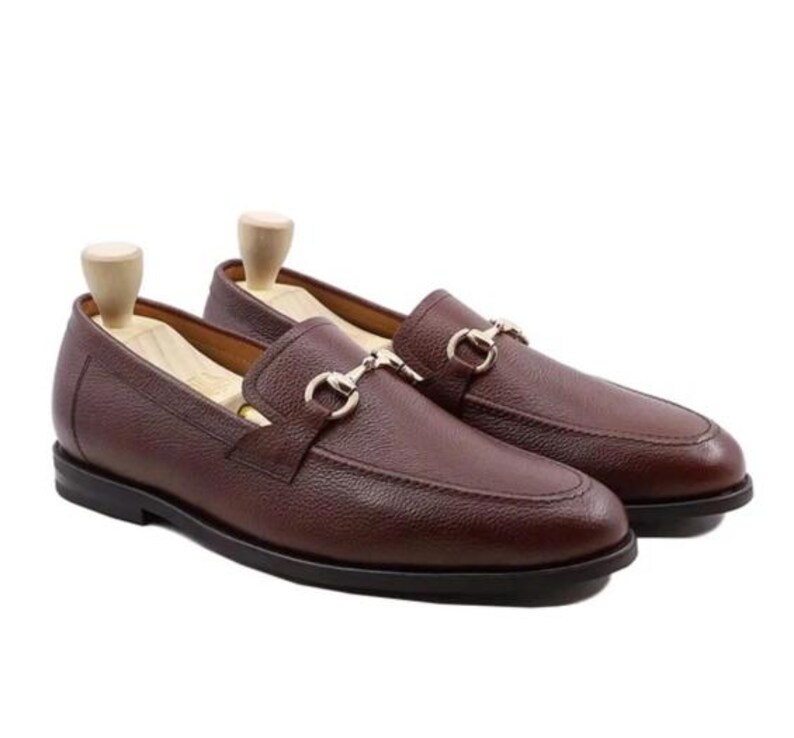 Handmade brown pebbled leather horsebit loafers for men featuring silver hardware, genuine leather lining, slip-on construction, and a luxury formal dress shoe design.