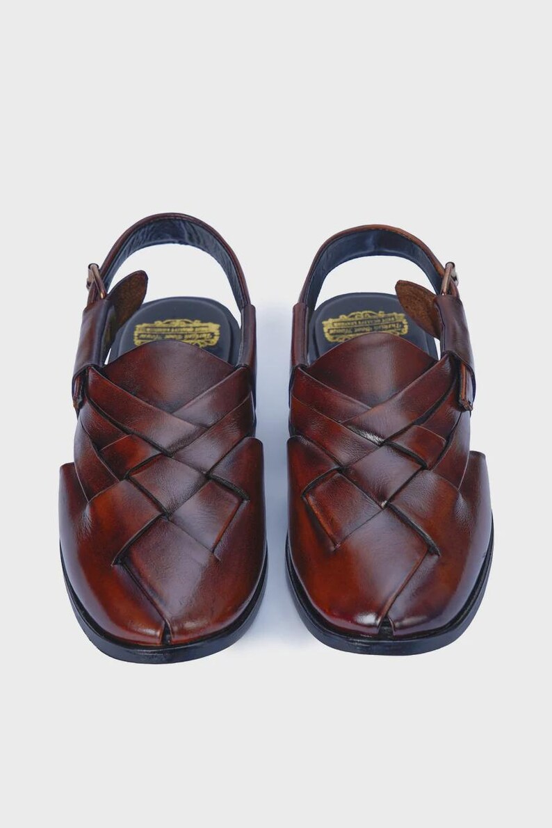 Handmade brown leather Peshawari sandals with woven closed-toe design and adjustable buckle for men's traditional and formal wear.