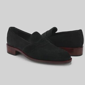 Handmade black suede penny loafers for men featuring a classic slip on silhouette, premium suede leather upper, leather sole, elegant formal design, luxury dress footwear ideal for weddings, business attire, office wear, and special occasions.