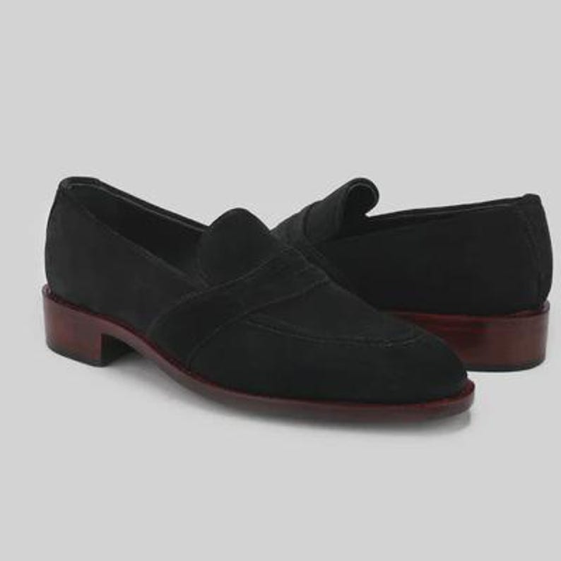 Handmade black suede penny loafers for men featuring a classic slip on silhouette, premium suede leather upper, leather sole, elegant formal design, luxury dress footwear ideal for weddings, business attire, office wear, and special occasions.