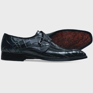 Handmade black crocodile embossed leather monk strap loafers for men featuring a textured buckle strap, premium leather lining, elegant slip-on design, and luxury craftsmanship for weddings, office wear, business meetings, and formal occasions.