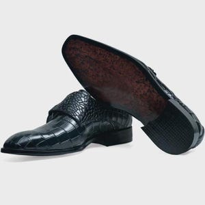 Handmade black crocodile embossed leather monk strap loafers for men featuring a textured buckle strap, premium leather lining, elegant slip-on design, and luxury craftsmanship for weddings, office wear, business meetings, and formal occasions.