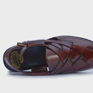 Handmade brown leather Peshawari sandals with woven closed-toe design and adjustable buckle for men's traditional and formal wear.