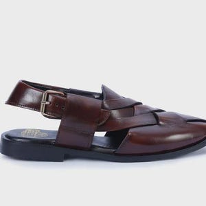 Handmade brown leather Peshawari sandals with woven closed-toe design and adjustable buckle for men's traditional and formal wear.