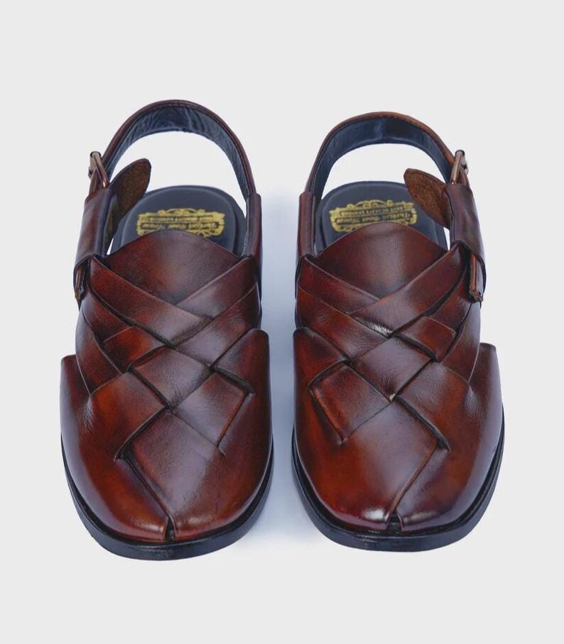 Handmade brown leather Peshawari sandals with woven closed-toe design and adjustable buckle for men's traditional and formal wear.