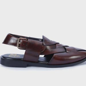 Handmade brown leather Peshawari sandals with woven closed-toe design and adjustable buckle for men's traditional and formal wear.