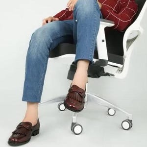 May include: A pair of brown leather loafers with fringe detailing. The loafers have a pointed toe and a low heel.