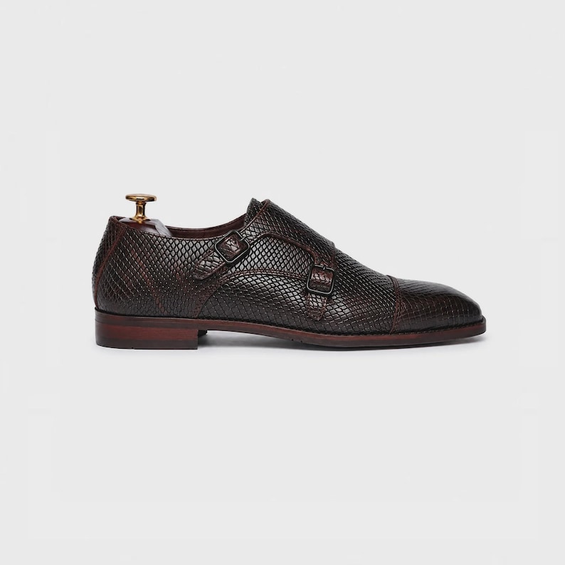 Handmade brown double monk strap shoes for men featuring snake embossed leather texture, cap toe design, dual buckle closure, leather lining and sole, luxury formal footwear ideal for weddings, business attire, office wear, and special occasions.