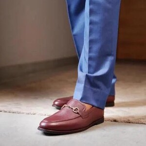 Handmade brown pebbled leather horsebit loafers for men featuring silver hardware, genuine leather lining, slip-on construction, and a luxury formal dress shoe design.