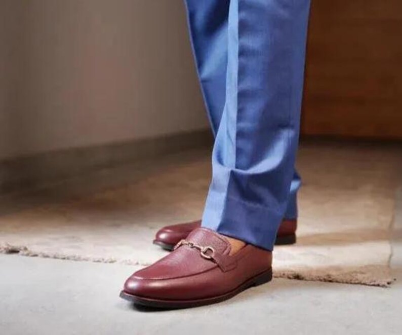 Handmade brown pebbled leather horsebit loafers for men featuring silver hardware, genuine leather lining, slip-on construction, and a luxury formal dress shoe design.