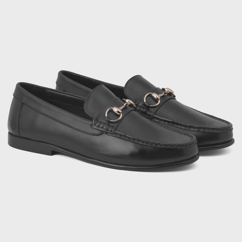 Handmade black leather horsebit loafers for men featuring polished premium leather and silver-tone hardware, luxury slip-on dress shoes ideal for weddings, groom attire, office wear, business meetings, formal events, parties, and sophisticated gentleman style.
