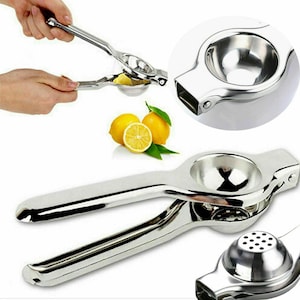 May include: A shiny, stainless steel lemon squeezer with a round bowl and long handles. The image shows the squeezer in use, with a lemon being squeezed, and also close-up views of the tool and lemons.