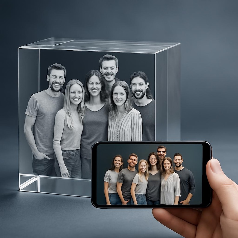 A large 3D crystal block showcasing a group photo of six people engraved in stunning detail. The hand holding a smartphone shows the original picture, demonstrating the photo-to-crystal transformation. The engraving captures each person’s expressions with depth and clarity inside the crystal cube.
Perfect for preserving family portraits, group memories, or special celebrations in elegant crystal form. An ideal custom keepsake or gift for reunions, anniversaries, or milestone events.