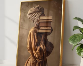 May include: A framed wall art print featuring a person wearing a tan headwrap and a long-sleeved golden-brown dress. The person holds a stack of three brown books in front of their face, obscuring their features. The frame is a thin, metallic gold.