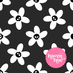 Op de afbeelding: Een herhalend patroon van witte bloemen met zwarte schedelcentra op een donkergrijze achtergrond. Een roze cirkelvormig logo met de tekst "haven and hue" staat rechtsonder. Het ontwerp is grillig en kan worden gebruikt voor stof of behang.