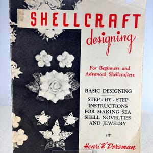 May include: Vintage book titled "Shellcraft Designing" with red lettering on a white and black background. The cover features shell designs and the text "For Beginners and Advanced Shellcrafters". The book provides step-by-step instructions for making sea shell novelties and jewelry.
