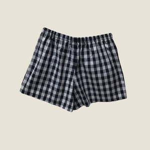 K&ouml;nnte beinhalten: Schwarze und wei&szlig;e karierte Boxershorts mit elastischem Bund.