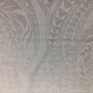 May include: A light gray fabric featuring a repeating pattern of intricate tribal-inspired motifs. The design includes curved lines, geometric triangles, and organic leaf-like shapes arranged in large circular formations across the surface.