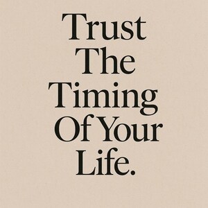 May include: A minimalist print on a beige background with the words "Trust The Timing Of Your Life" in a bold, black serif font. The text is centered, creating a balanced and calming aesthetic.