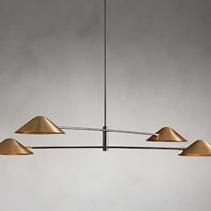 May include: A modern, four-light pendant chandelier with a curved, black metal frame and gold-toned, cone-shaped shades.