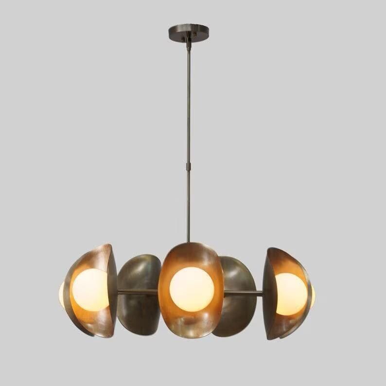 May include: A modern, brass chandelier with six round, frosted glass shades. The chandelier has a circular design with the shades arranged in a staggered pattern.