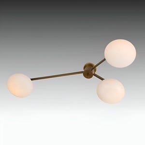 Peut inclure: Un luminaire de plafond en laiton avec trois globes en verre blanc. Le luminaire a un design moderne avec un moyeu central et trois bras s'étendant vers les globes.