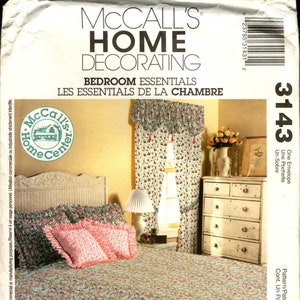 May include: A McCall's Home Decorating pattern for a bedroom, featuring a floral patterned bedspread, pillows, and curtains. The pattern is for a valance, a pillowcase, and a bed skirt. The pattern number is 3143.