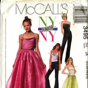 May include: McCall's sewing pattern for a junior size dress. The pattern includes three different styles: a pink strapless gown, a yellow strapless gown, and a black strapless top with black pants. The pattern number is 3495.