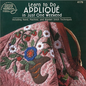 May include: A book titled "Learn to Do Appliqué in Just One Weekend" by Nancy Brenan Daniel. The book cover features a close-up of a red and white quilt with an appliqué design of a flower pot with flowers and strawberries.