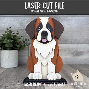 May include: A multi-layered laser cut file of a Saint Bernard dog featuring brown, white, and black colors. The text LASER CUT FILE, INSTANT DIGITAL DOWNLOAD, LASER READY, SVG FORMAT, and KERF KAT DESIGNS is visible on the image.