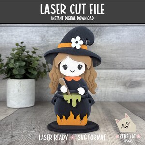 May include: A laser cut file design featuring a cartoon witch with long brown hair, a black hat with an orange band and white flower, and a black dress. The witch stirs a black cauldron with green liquid, set above orange flames on a round base.