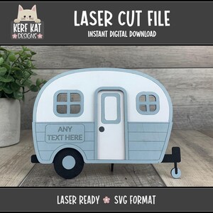 May include: A laser-cut wooden camper in white and pale blue, with the text "LASER CUT FILE" and "INSTANT DIGITAL DOWNLOAD". The design includes the text "ANY TEXT HERE" and "LASER READY SVG FORMAT".