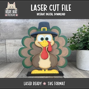 May include: A wooden turkey decoration with a pilgrim hat, green and brown feathers, and a red wattle. The text "LASER CUT FILE" and "INSTANT DIGITAL DOWNLOAD" are displayed at the top. The bottom text reads "LASER READY SVG FORMAT".