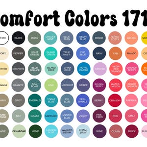 Puede incluir: Una carta de colores con el texto "Comfort Colors 1717" en la parte superior. La carta muestra numerosas muestras de color en formas circulares, cada una etiquetada con un nombre de color &uacute;nico, que van del blanco al negro y varias tonalidades.
