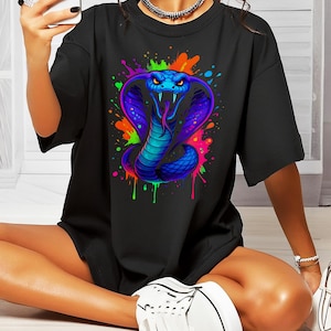 May include: Black t-shirt featuring a colourful graphic of a cobra snake with paint splatters.
