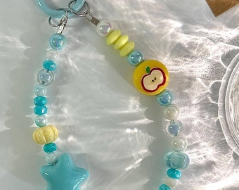 Charm para teléfono de Apple azul y amarillo: Accesorio coreano con cuentas de estrella