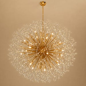 May include: A spherical chandelier featuring a gold-toned metal frame with numerous radiating thin rods. Each rod is tipped with a small, clear crystal bead, creating a starburst effect. The fixture is suspended by a gold chain from a central point.