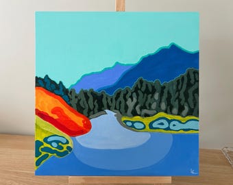May include: Square acrylic painting of a landscape scene. The artwork features a blue lake, dark green trees, and blue mountains under a light blue sky. A red and orange shape is on the left side of the painting.