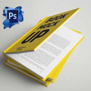 May include: A stack of yellow hardcover books with the text "BOOK MOCK UP" in large black letters. The words "HARDCOVER EDITION" are also visible. The pages are white with black text. A blue and white Photoshop logo is in the upper left corner.