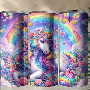 May include: A tumbler featuring a colorful unicorn design. The artwork includes a rainbow, butterflies, flowers, and clouds. The unicorn has a golden horn and a flowing mane and tail in rainbow colors. The background is a dreamy, fantasy scene.