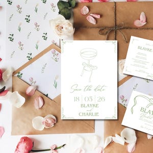 May include: Save the date card with a green line drawing of a champagne flute and a bow. The text reads "Save the date 18|05|26 Blayke and Charlie".